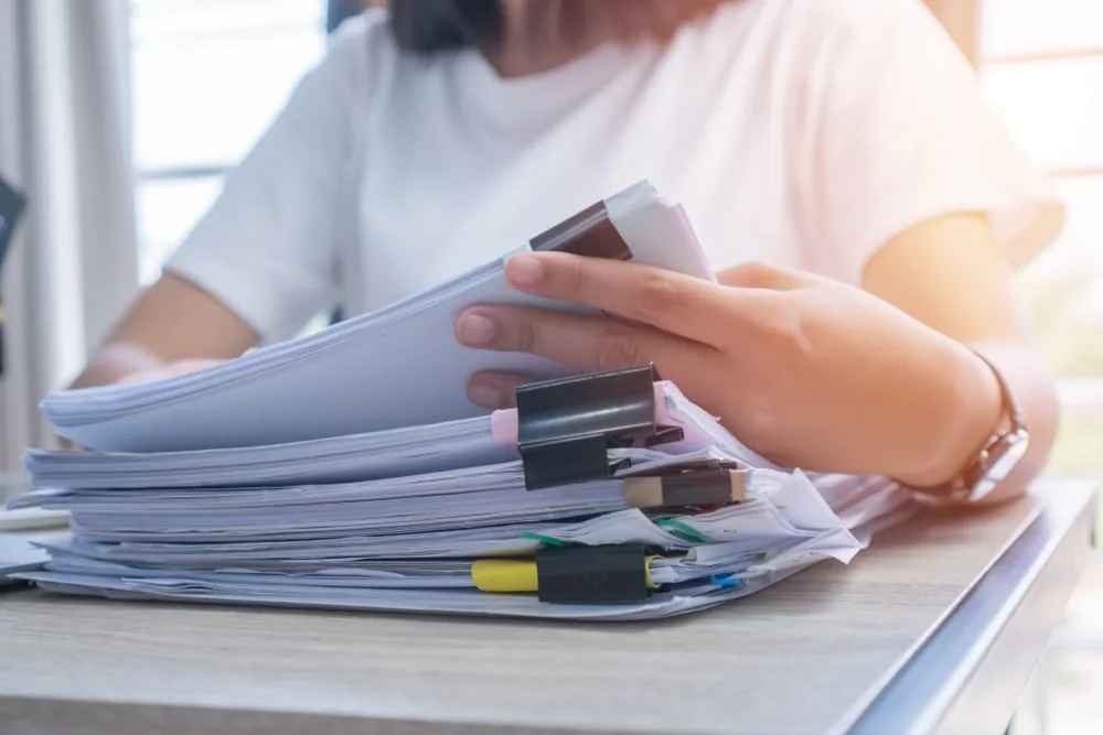 Printed files being reviewed for document translation services