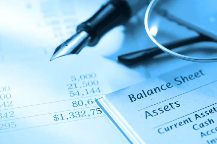 Balance sheet and pen prepared for financial document translation services